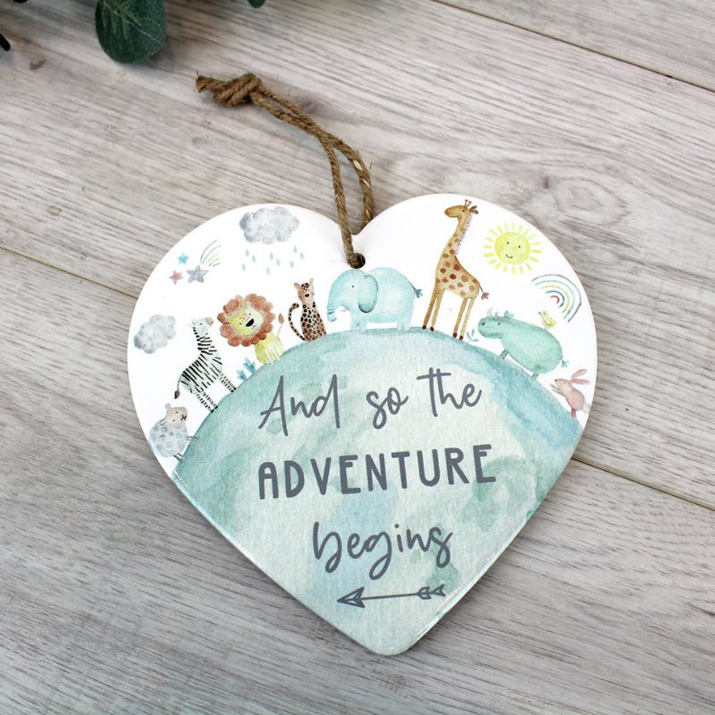 This super cute ceramic heart hanger has a jute string hanging loop and features the words, 'And So the Adventure Begins'.  The ceramic heart hanger features a pretty animal design in muted pastel shades.