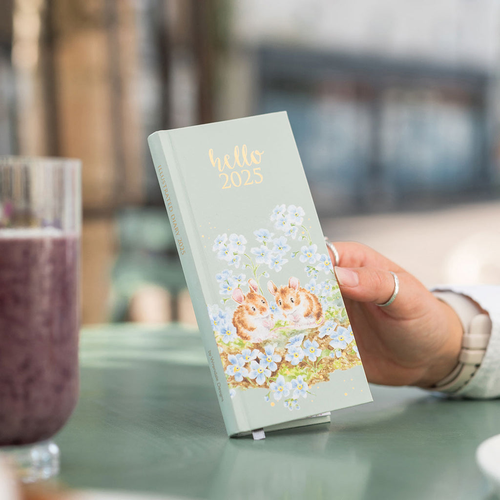 hard cover slim diary with pale green background and illustrations of 2 mice sitting among blue flowers