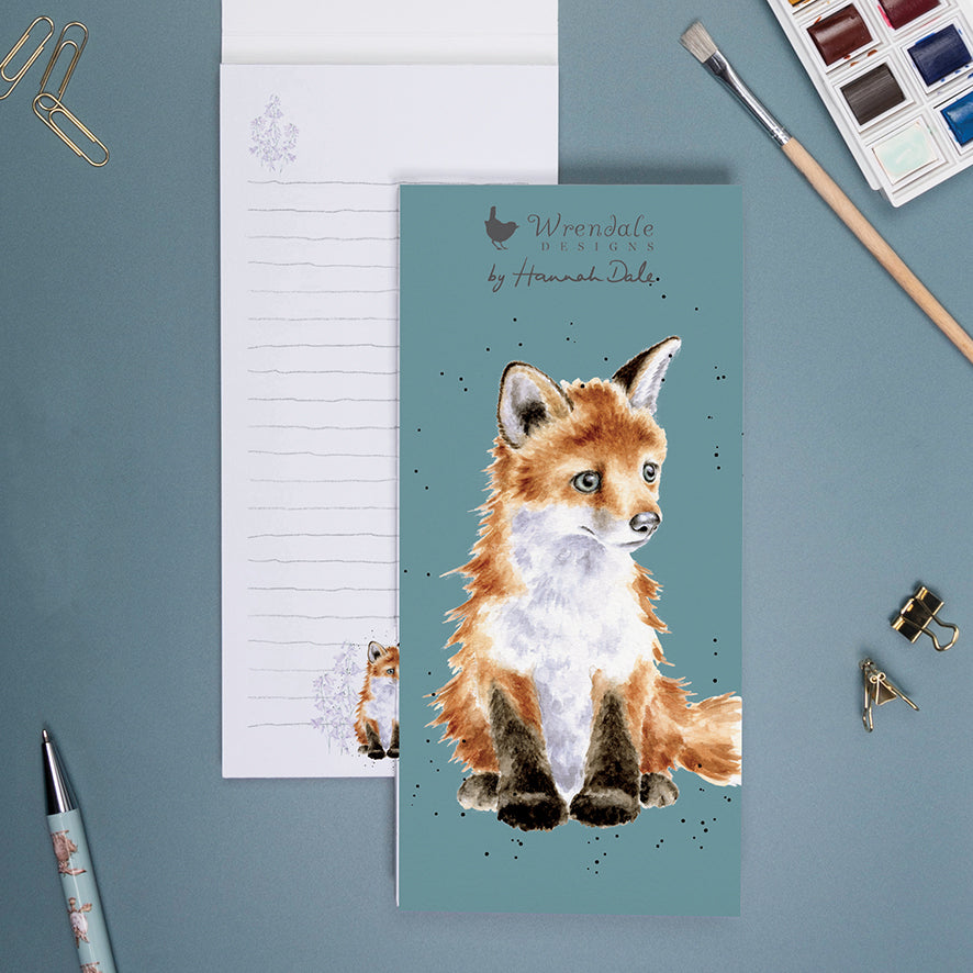 slim memo pad with picture of a fox on the front. The brand name wrendale designs by hannah dale is also on the front of the notepad.  The background behind the cow is teal in colour