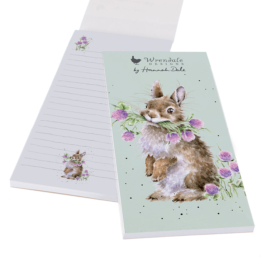 shopping list notepad with pale green front cover and illustration of a rabbit holding a bunch of flowers. there is a wrendale designs logo at the top.  The open notebook shows mini illustrations at the bottom of each lined page.