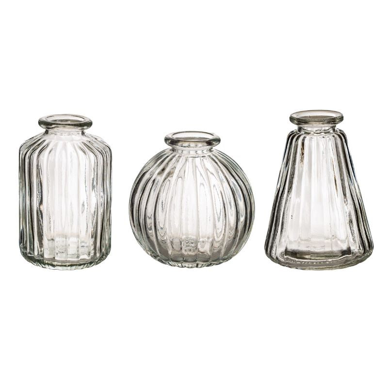 set of three clear glass cases with ribbed edges.  each is a differnt shape including a jar shape, conical shape and sphere shape