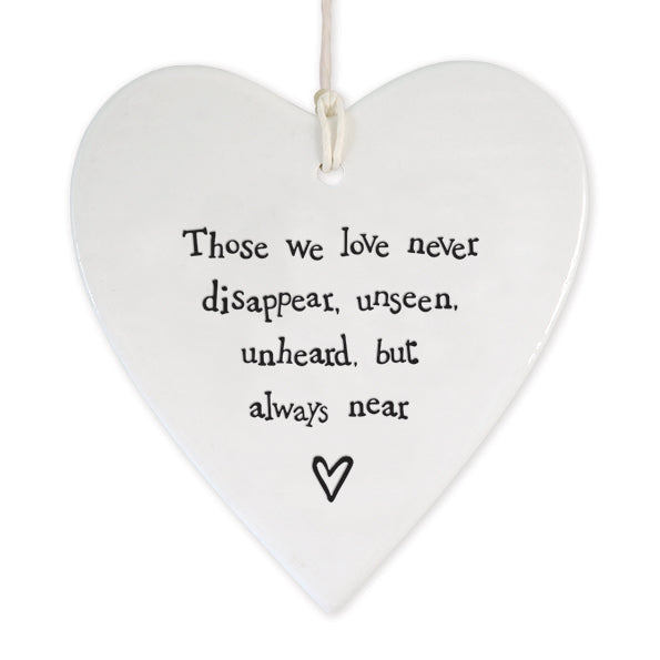 white porcelain heart with twisted paper cord hanging loop.  The words Those we love never disappear, unseen, unheard, but always near are on the front with a little heart underneath