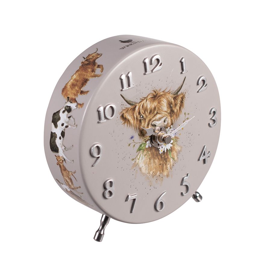 matt grey mantel clock with highland cow design on front and various cow illustrations around the side..  The numbers are embossed and have a silver metallic finish.