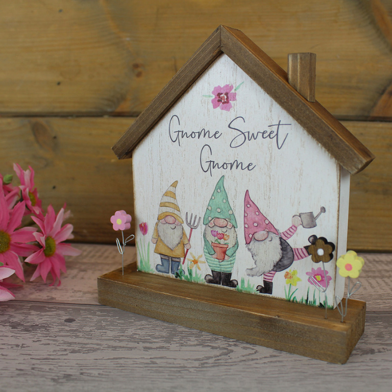 gnome sweet gnome wooden house shaped free-standing sign with pictures of three gnomes and little wooden flowers