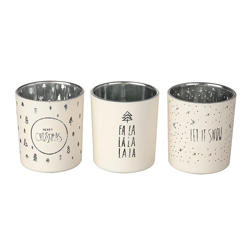 set of 3 white glass tealight candle holders with assorted inscriptions including merry christmas, fa la.la.la.la & let it snow